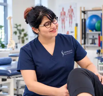 Gargi, SPINOFIT physiotherapist, wearing navy clinical scrubs in a physiotherapy clinic